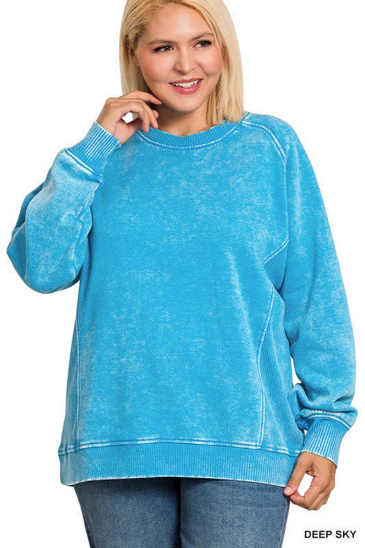 Woman wearing blue sweatshirt in front of white background