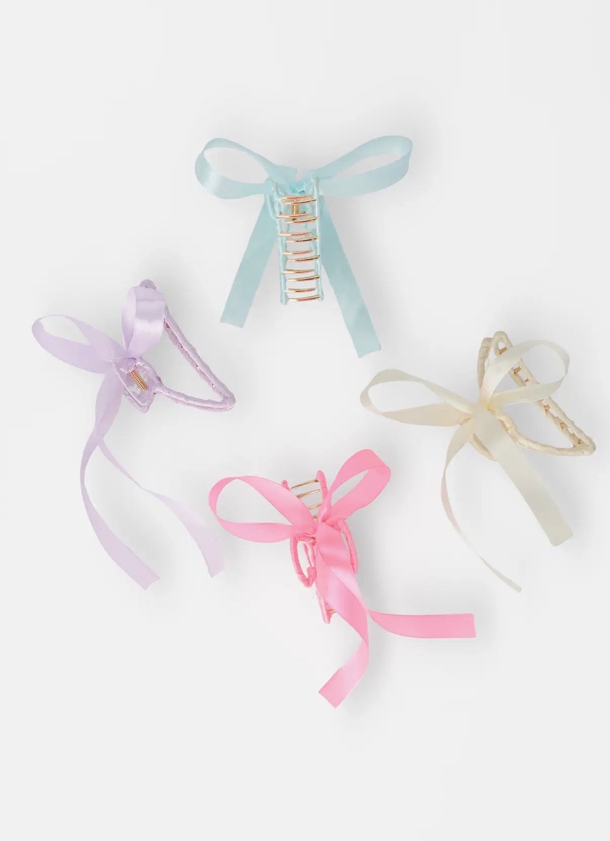 Set of four hair clips with ribbons on a white background