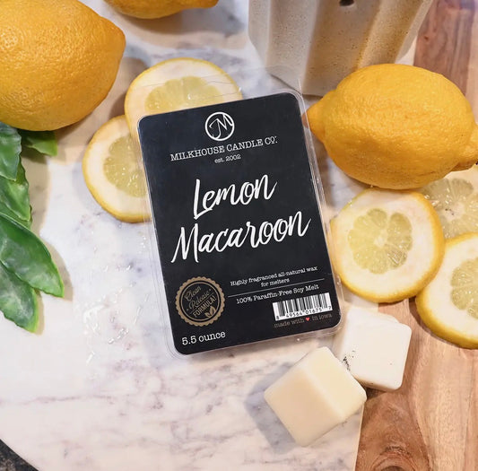 Milkhouse Candle Co. Lemon Macaron wax melt package surrounded by lemons on a marble surface