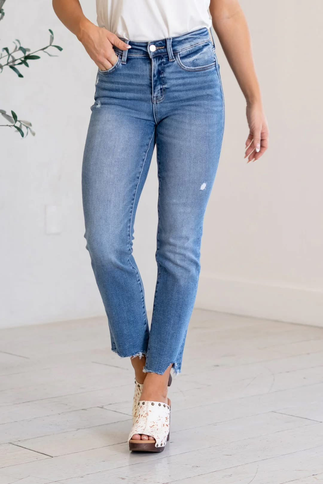 Person wearing blue jeans with a white background