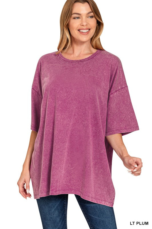 Woman wearing a light plum tee with blue jeans on a white background