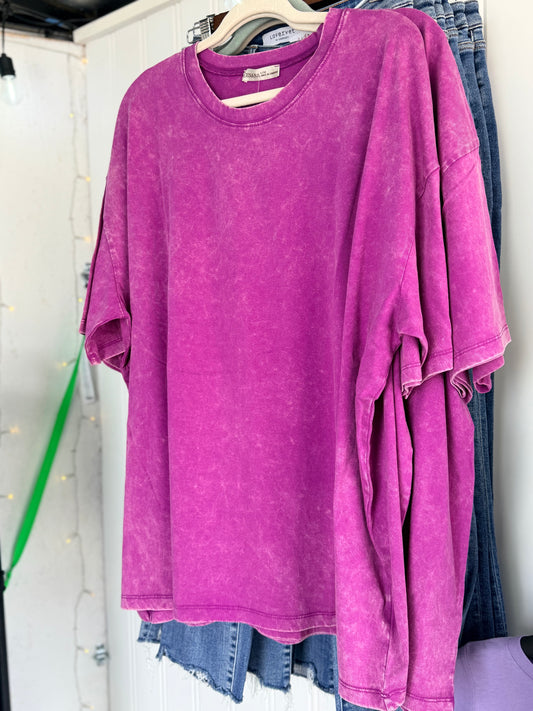 Plum shirt on a hanger with a white background