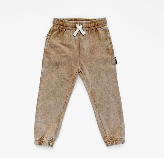 Tan acid wash jogger pants on a white background