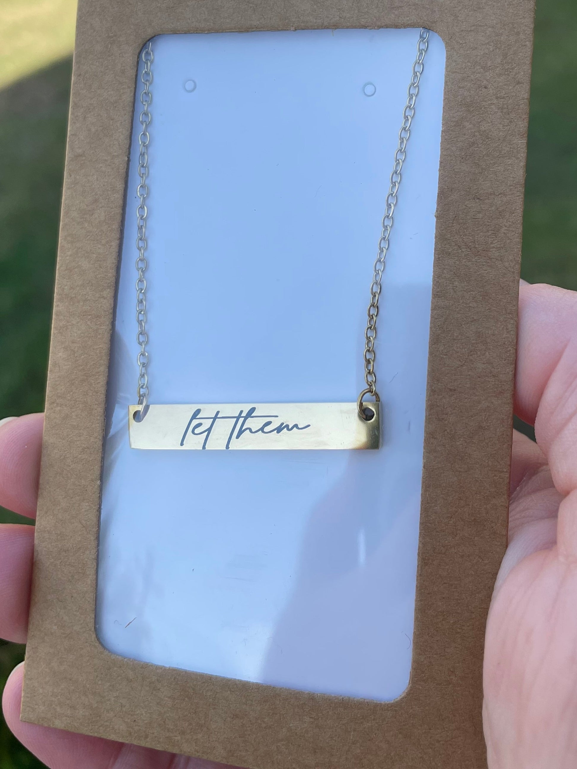 Custom engraved necklace with "let them" script design