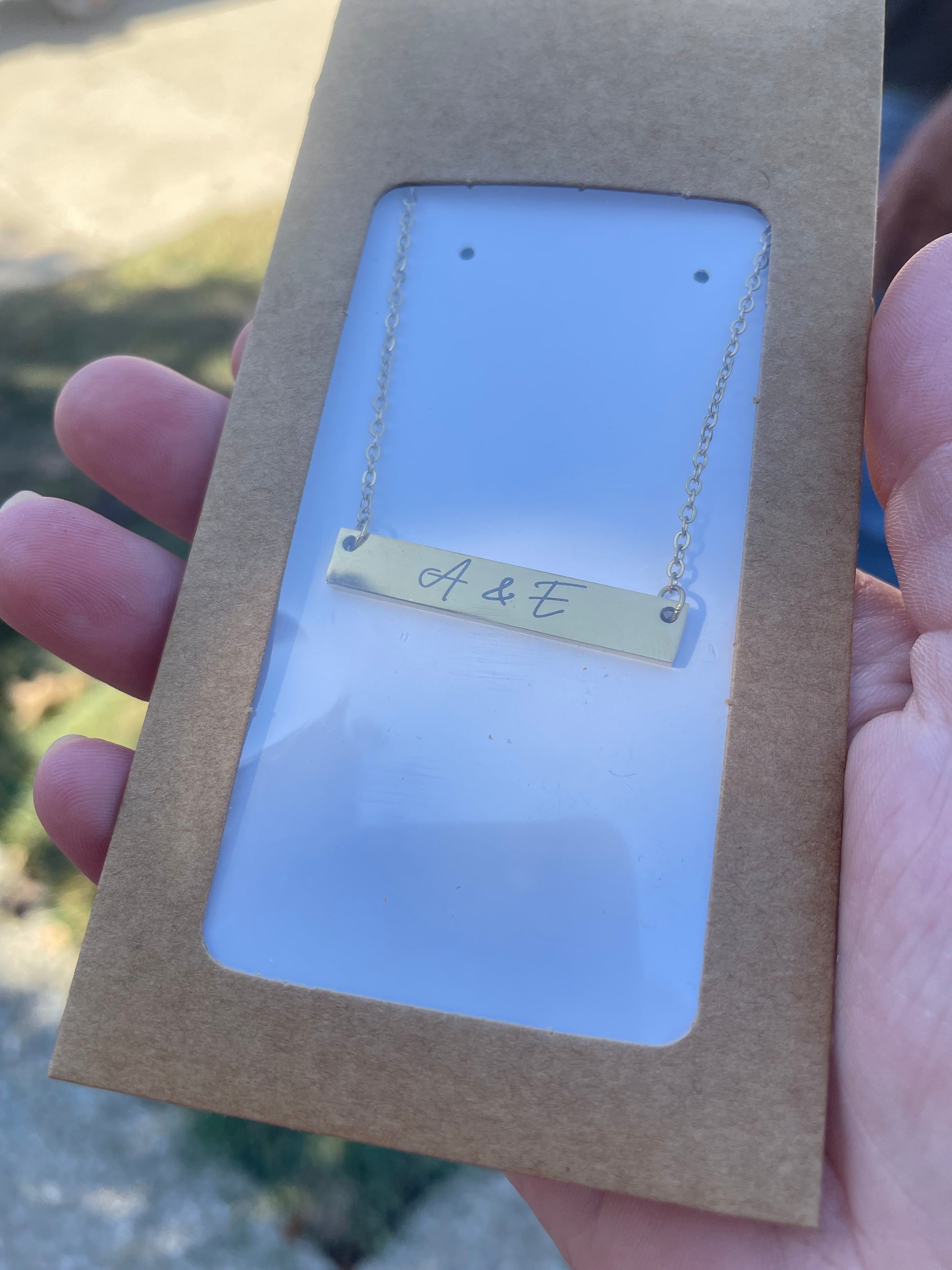 Custom engraved bar necklace with "A & E" script design