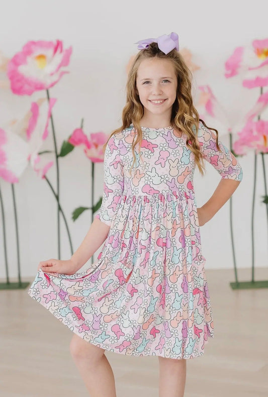 Young girl wearing a floral easter dress with a soft focus background