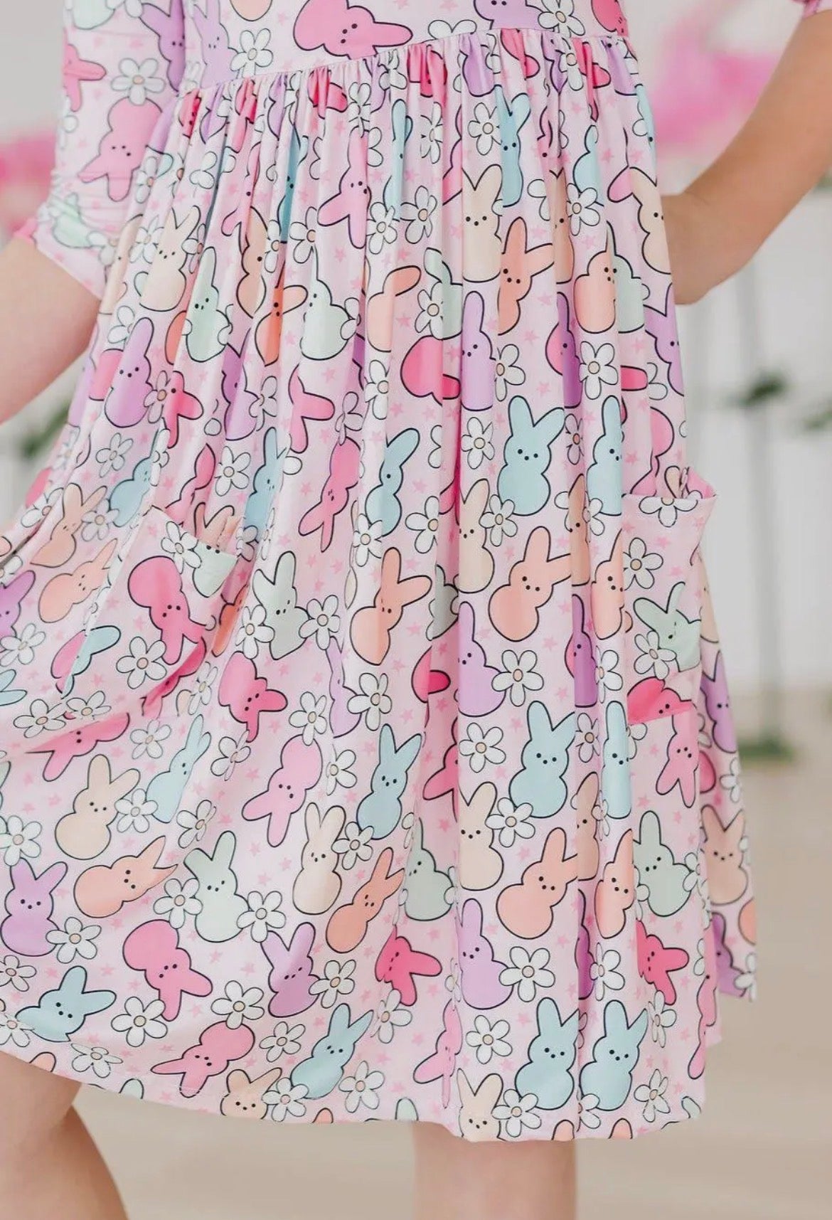 Pastel-colored bunny patterned dress on a blurred background