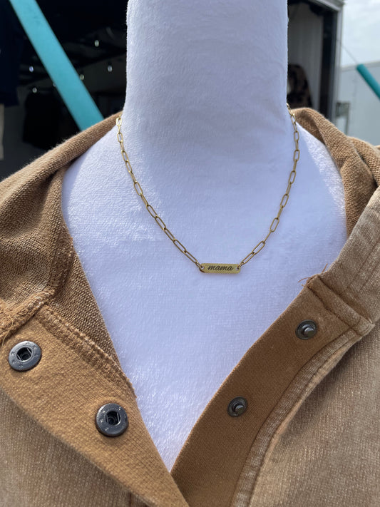 Mannequin wearing a gold chain necklace with a plain background