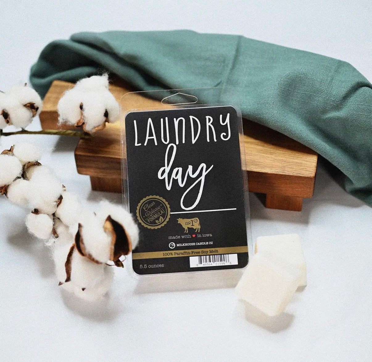 Laundry day wax melts with green fabric and cotton on a white background