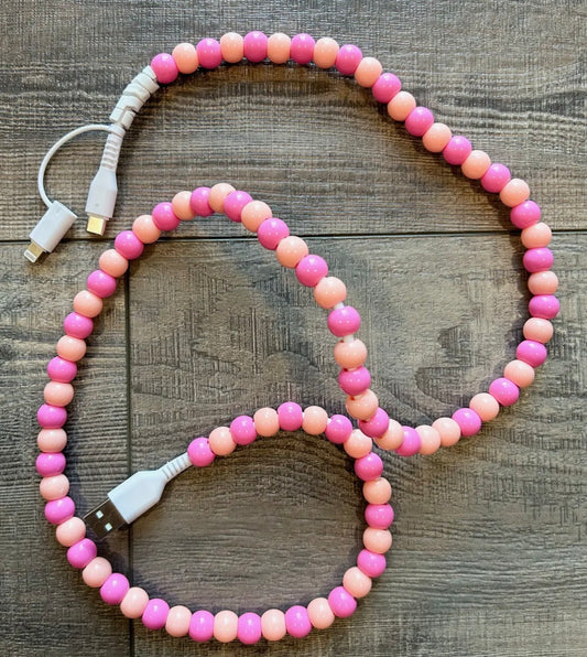 Beaded cable with USB connectors on a wooden surface