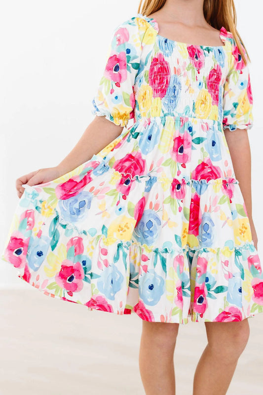 Colorful floral dress with short sleeves on a white background