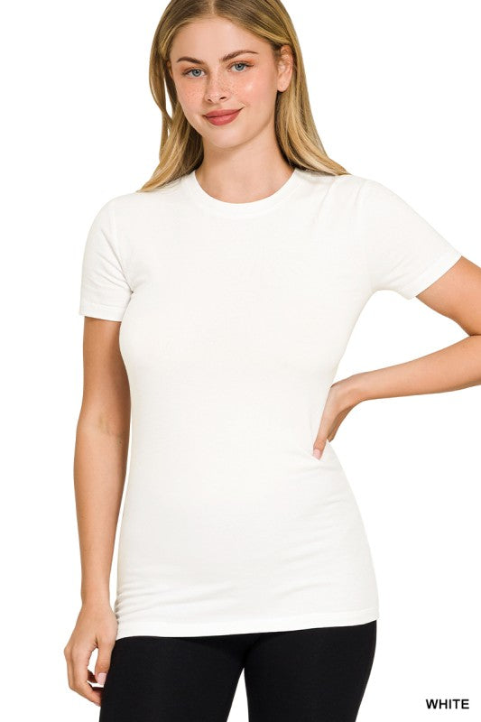 Woman wearing white t-shirt and black pants in front of a white background