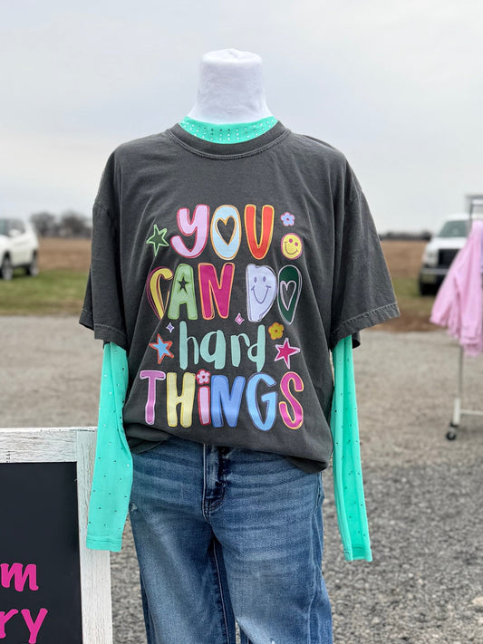 Mannequin wearing a graphic t-shirt with a design saying "you can do hard things" and jeans